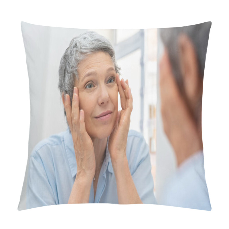 Personality  Beautiful Senior Woman Checking Her Face Skin And Looking For Blemishes. Portrait Of Mature Woman Massaging Her Face While Checking Wrinkled Eyes In The Mirror. Wrinkled Lady With Grey Hair Checking Wrinkles Around Eyes, Aging Process. Pillow Covers