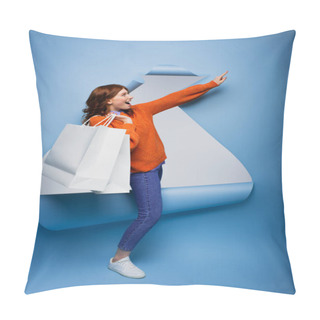 Personality  Young Amazed Woman Holding Shopping Bags And Gesturing On Blue Ripped Paper Background  Pillow Covers