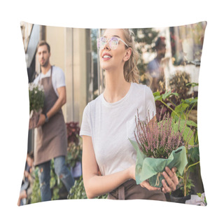 Personality  Attractive Florist Holding Potted Salvia Flowers Near Flower Shop And Looking Up Pillow Covers