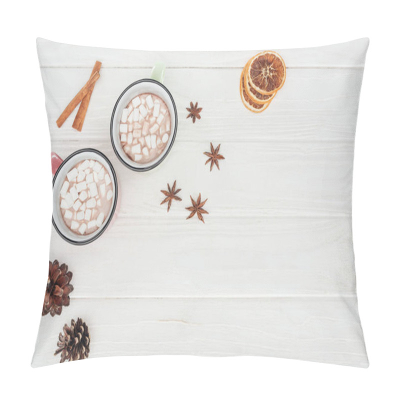 Personality  flat lay with cups with hot chocolate and marshmallows, cinnamon sticks and pine cones on wooden table pillow covers