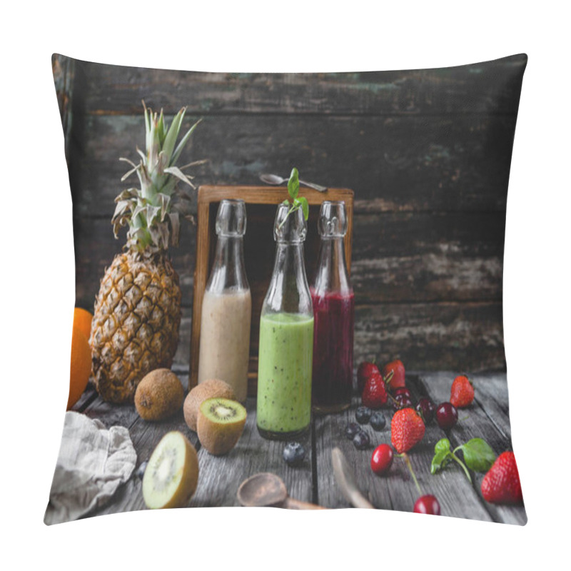 Personality  Organic fruit smoothies in glass bottles on wooden background with assorted fruits pillow covers