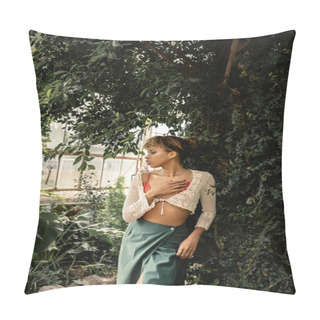 Personality  Side View Of Modern Young African American Woman In Knitted Top And Skirt Touching Chest And Standing Near Plants In Indoor Garden, Stylish Woman Enjoying Lush Tropical Surroundings Pillow Covers