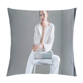 Personality  Portrait Of Beautiful Brunette Woman In Trendy White Clothes Sitting On Chair And Looking At Camera On Grey  Pillow Covers