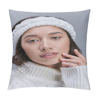 Personality  Portrait Of Charming Asian Woman In Warm Headband Touching Face And Looking At Camera On Grey Pillow Covers