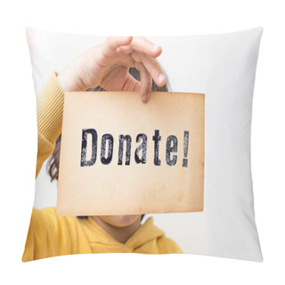 Personality  Child Hand Holding A Piece Of Paper With The Word Donate! Stamped With Black Ink, Close Up Pillow Covers