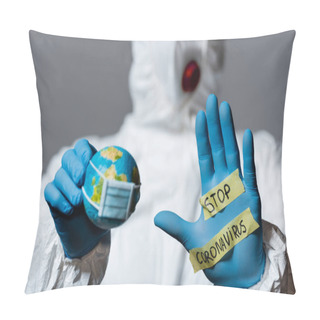 Personality  Selective Focus Of Man In Hazmat Suit Holding Globe And Showing Hand With Stop Coronavirus Lettering Isolated On Grey  Pillow Covers