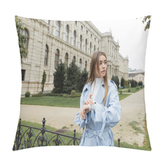 Personality  Pretty Woman In Blue Trench Coat Checking Time On Smart Watch While Waiting Near Historical Building In Vienna  Pillow Covers