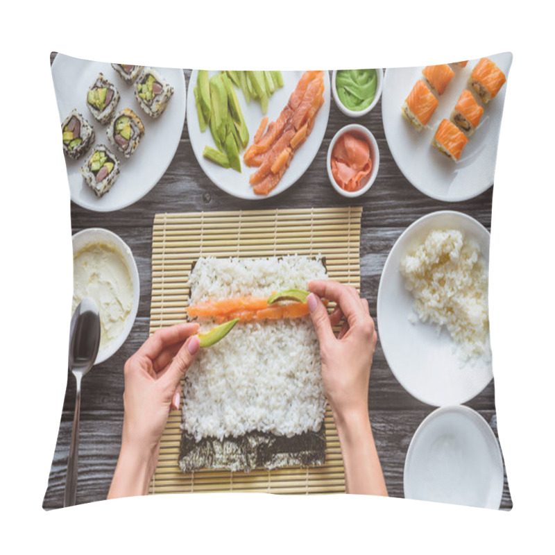 Personality  cropped shot of person cooking delicious sushi roll with salmon, rice, cucumber, avocado and nori  pillow covers