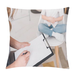 Personality  Cropped Shot Of Psychologist With Clipboard Sitting In Front Of Little Child In Office Pillow Covers