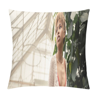 Personality  Low Angle View Of Confident Young African American Woman In Summer Knitted Top Looking Away While Standing Near Plants In Blurred Orangery, Stylish Woman With Tropical Backdrop, Banner  Pillow Covers