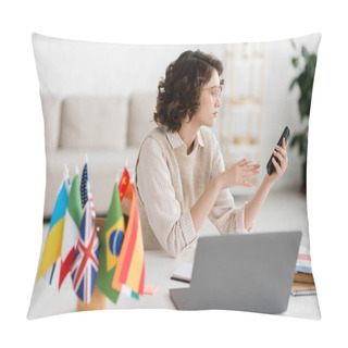 Personality  Young Language Teacher In Glasses Holding Smartphone Near Laptop And International Flags On Blurred Foreground  Pillow Covers