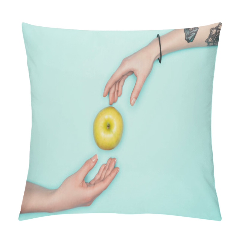 Personality  cropped shot of women passing green apple isolated on turquoise pillow covers