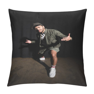 Personality  Full Length Of Stylish Eastern Hip Hop Singer In Cap Gesturing While Standing On Black  Pillow Covers
