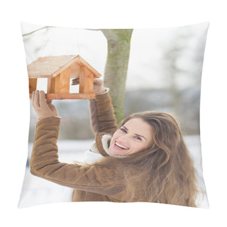 Personality  Smiling Young Woman Hanging Bird Feeder On Tree In Winter Outdoo Pillow Covers