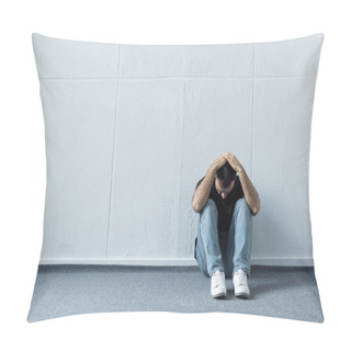 Personality  Depressed Man Sitting On Floor Near White Wall And Holding Hands On Head Pillow Covers