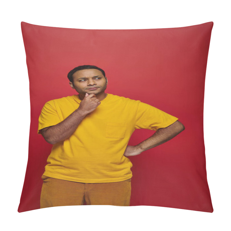 Personality  Pensive Indian Man In Bright Casual Attire Standing With Hand Near Chin On Red Background In Studio Pillow Covers