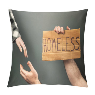 Personality  A Woman Extends A Helping Hand To A Man Holding A Cardboard Box With The Text Homeless. Dark Background Of A Greenish Hue. The Concept Of A Social Problem With People Without A Home And Vagabonds. Pillow Covers