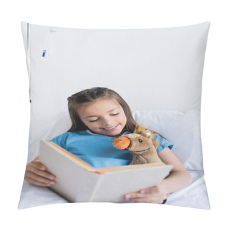 Personality  Cheerful Kid Holding Book And Looking At Soft Toy On Bed In Clinic  Pillow Covers
