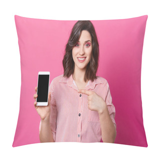Personality  Studio Shot Of Attractive Woman Stands Smiling And Pointing At Mobile Phone With Empty Screen, Feels Happy, Dressed In Elegant Clothes, Models Posing Over Pink Studio Wall. Copy Space For Promotion. Pillow Covers