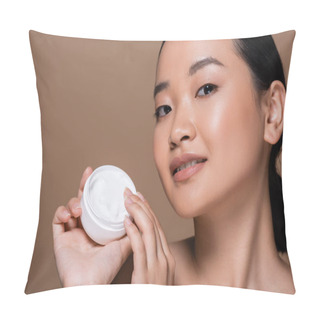 Personality  Young Asian Woman Holding Cosmetic Cream And Looking At Camera Isolated On Brown  Pillow Covers