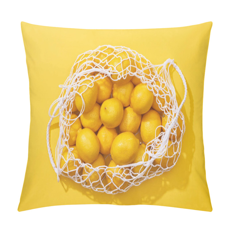 Personality  top view of fresh ripe whole lemons in eco string bag on yellow background pillow covers