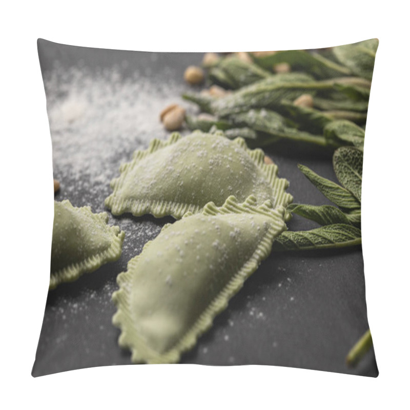 Personality  selective focus of green ravioli near sage, flour and pine nuts on black table pillow covers