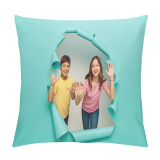 Personality  Smiling Multiethnic Kids In Colorful T-shirts Waving Hands At Camera While Celebrating World Protection Children Day Near Hole In Blue Paper Background Pillow Covers