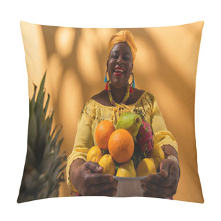 Personality  Smiling Middle Aged African American Woman Holding Metal Bowl With Fruits On Orange Pillow Covers