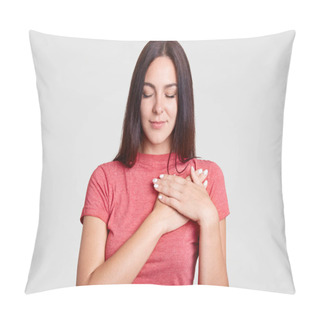 Personality  Calm Brunette Female With Closed Eyes, Keeps Both Palms On Heart, Feels Gratitude, Being Touched By Something, Dressed In Casual Pink T Shirt, Isolated Over White Background. Body Language Concept Pillow Covers