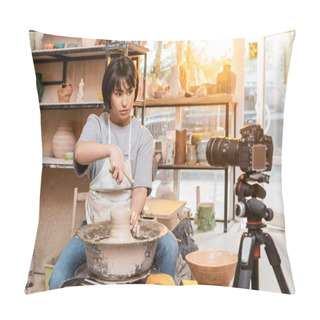 Personality  Young Asian Female Potter In Apron Pointing With Finger While Working With Clay On Pottery Wheel And Looking At Digital Camera In Workshop At Sunset, Artisan Creating Unique Pottery Pieces Pillow Covers