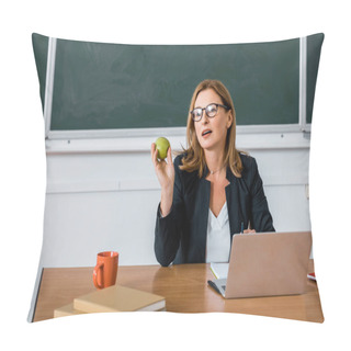 Personality  Female Teacher Sitting At Computer Desk And Holding Apple In Classroom Pillow Covers