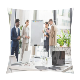Personality  Selective Focus Of Four Multiethnic Businesspeople Near Flipchart And Table With Laptops And Glasses Of Water On Foreground Pillow Covers