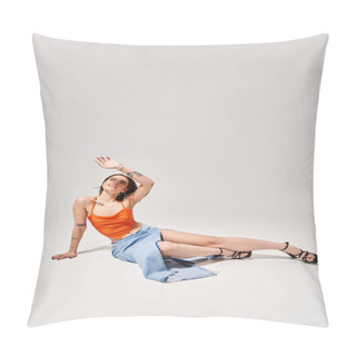 Personality  A Young Woman With Brunette Hair Dressed In An Orange Top Is Peacefully Laying On The Floor In A Studio Setting. Pillow Covers