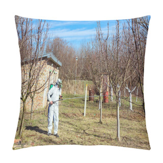 Personality  Farmer In Protective Clothing And Gas Mask Sprays Of Fruit Trees In Orchard Using Long Sprayer To Protect Them With Chemicals From Fungal Disease Or Vermin At Early Springtime. Pillow Covers