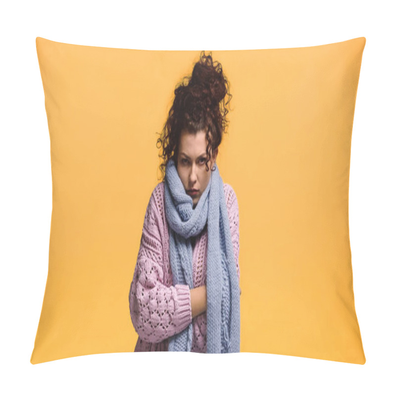 Personality  displeased woman freezing in warm sweater and scarf isolated on orange pillow covers