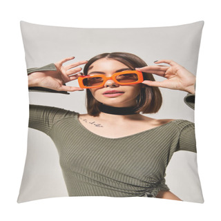 Personality  A Stylish Young Woman With Brunette Hair Wearing A Green Shirt And Orange Sunglasses In A Studio Setting. Pillow Covers
