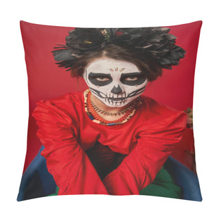 Personality  Woman In Scary Sugar Skull Makeup And Colorful Beads Looking At Camera In Armchair On Red Pillow Covers