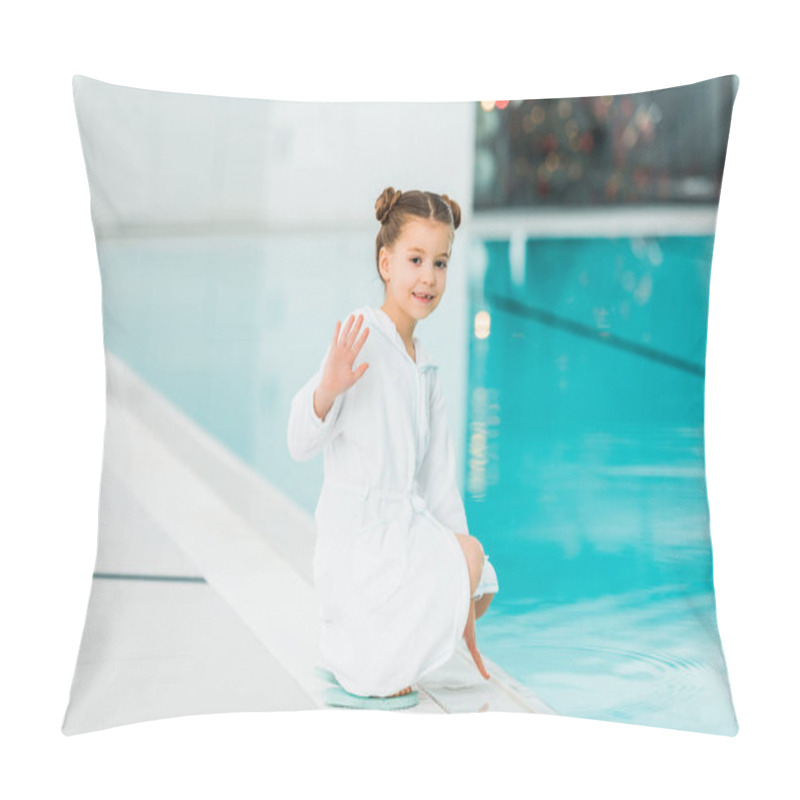 Personality  cute child sitting in bathrobe ner swimming pool and waving hand saying hello  pillow covers