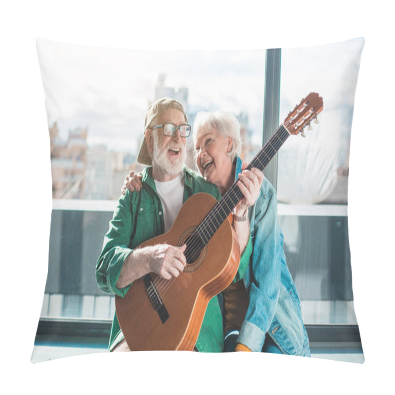 Personality  Senior husband and wife looking amused with guitar pillow covers