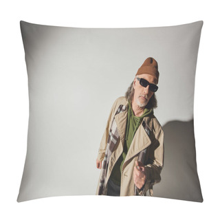 Personality  Senior And Bearded Man In Dark Sunglasses, Beanie Hat, Plaid Scarf And Beige Trench Coat Looking At Camera On Grey Background With Shadow And Copy Space, Hipster Style, Fashion And Age Concept Pillow Covers