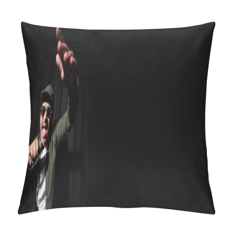 Personality  emotional indian hip hop performer with raised hand singing in microphone on black, banner pillow covers