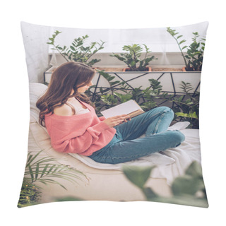 Personality  Selective Focus Of Young Woman Reading Book While Sitting With Crossed Legs Near Green Plants At Home Pillow Covers