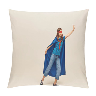 Personality  Happy Girl In Superhero Costume With Blue Cloak And Red Mask On Face, Standing In Denim Jeans And T-shirt With Outstretched Hand While Reaching Something On Grey Background  Pillow Covers