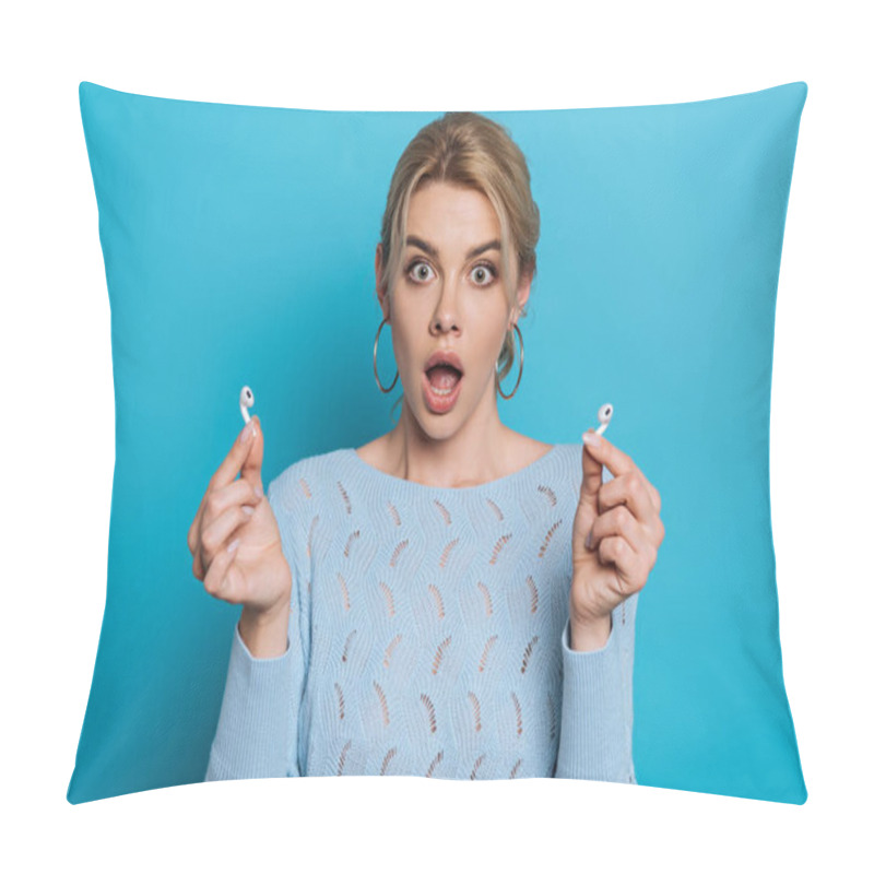 Personality  shocked girl with open mouth showing wireless earphones on blue background pillow covers