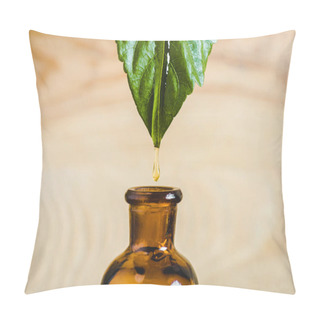 Personality  Close Up Of Essential Oil Dripping From Leaf Into Glass Bottle Isolated On Beige Pillow Covers