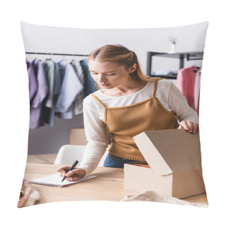 Personality  Young Seller Writing Order In Notebook Near Carton Package In Clothes Showroom Pillow Covers