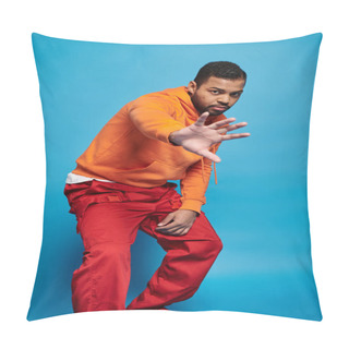 Personality  Attractive African American Man In Vibrant Outfit Hiding From Camera With Hand On Blue Background Pillow Covers