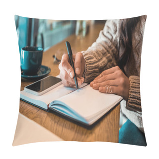 Personality  Cropped View Of Freelancer Writing In Planner With Smartphone In Cafe  Pillow Covers