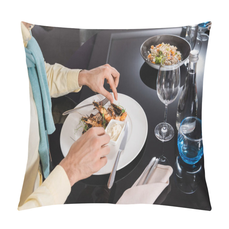 Personality  Cropped view of man sitting near delicious shrimps on plate in hotel room  pillow covers
