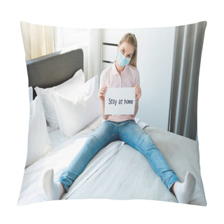 Personality  Woman In Medical Mask Holding Paper With Stay At Home Lettering While Sitting On Bed  Pillow Covers